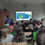 Zdjęcie przedstawia uczniów oglądających połączenie on-line  z astronautą Sławoszem Uznańskim-Wiśniewskim przebywającym w kosmosie.