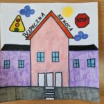 praca plastyczna przedstawiająca kolorowy budynek bezpiecznej szkoły